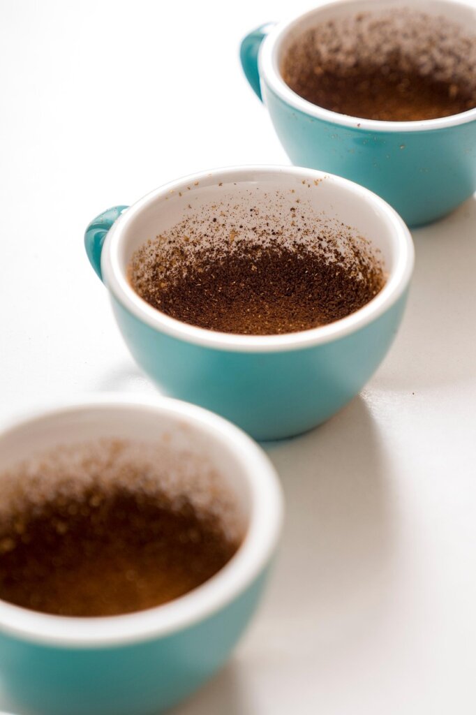 coffee grounds in small white dish inside fridge