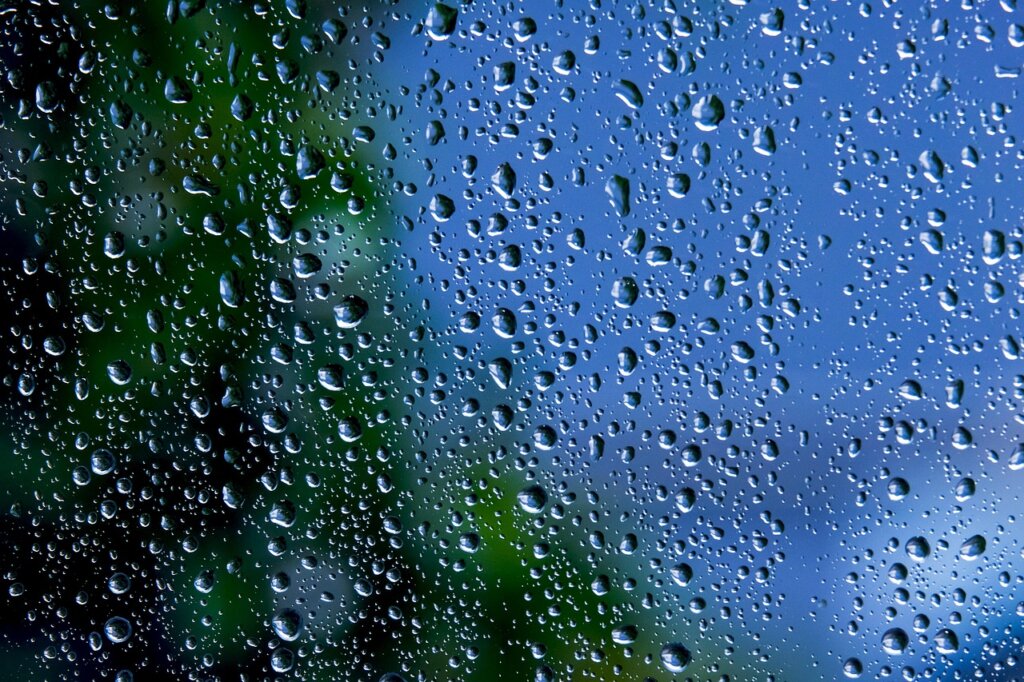 cleaning window with crumpled newspaper, close-up