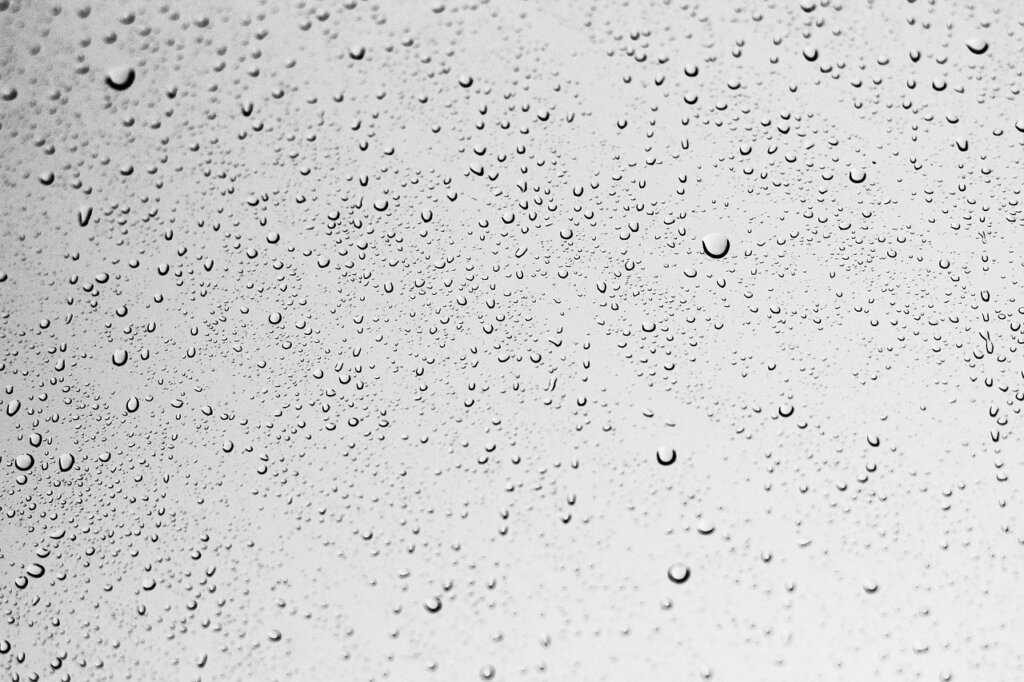 water repellent coating being applied to clear glass window