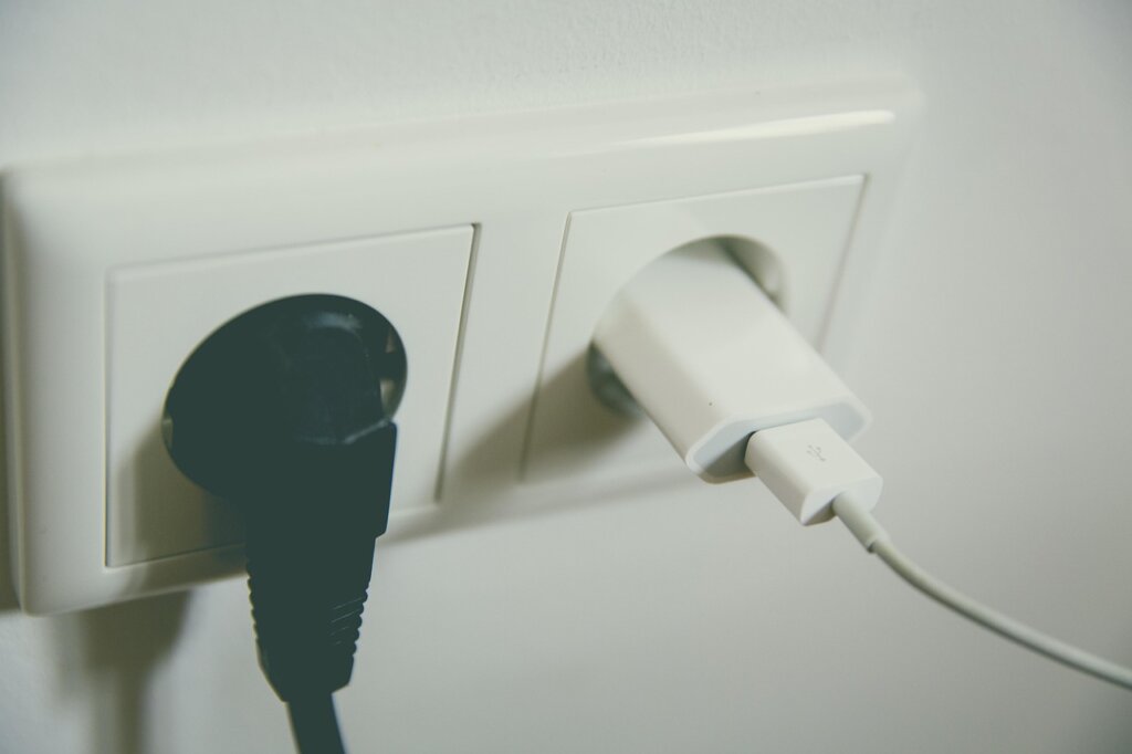 USB rechargeable electric mosquito bat charging on desk