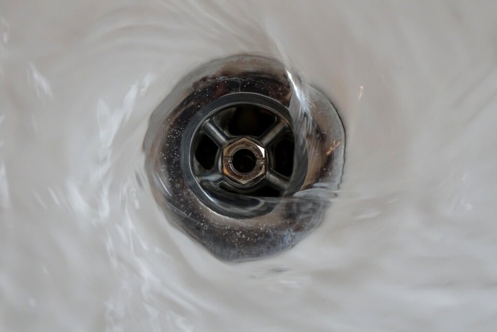 silicone hair catcher placed over bathroom sink drain