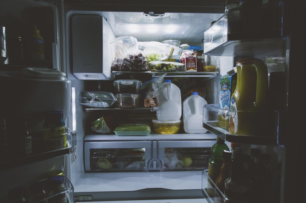 organized refrigerator vegetable drawer with labeled containers