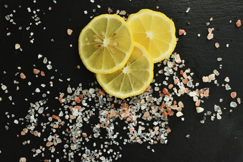 salt and lemon on wooden cutting board for sanitizing