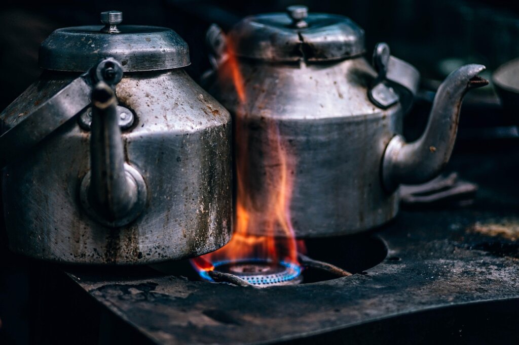 baking soda and water boiling in burnt stainless steel pot on stove