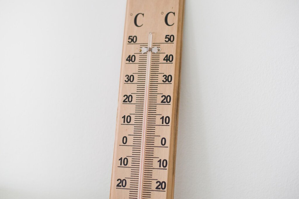 thermometer near window showing temperature change before and after foam tape