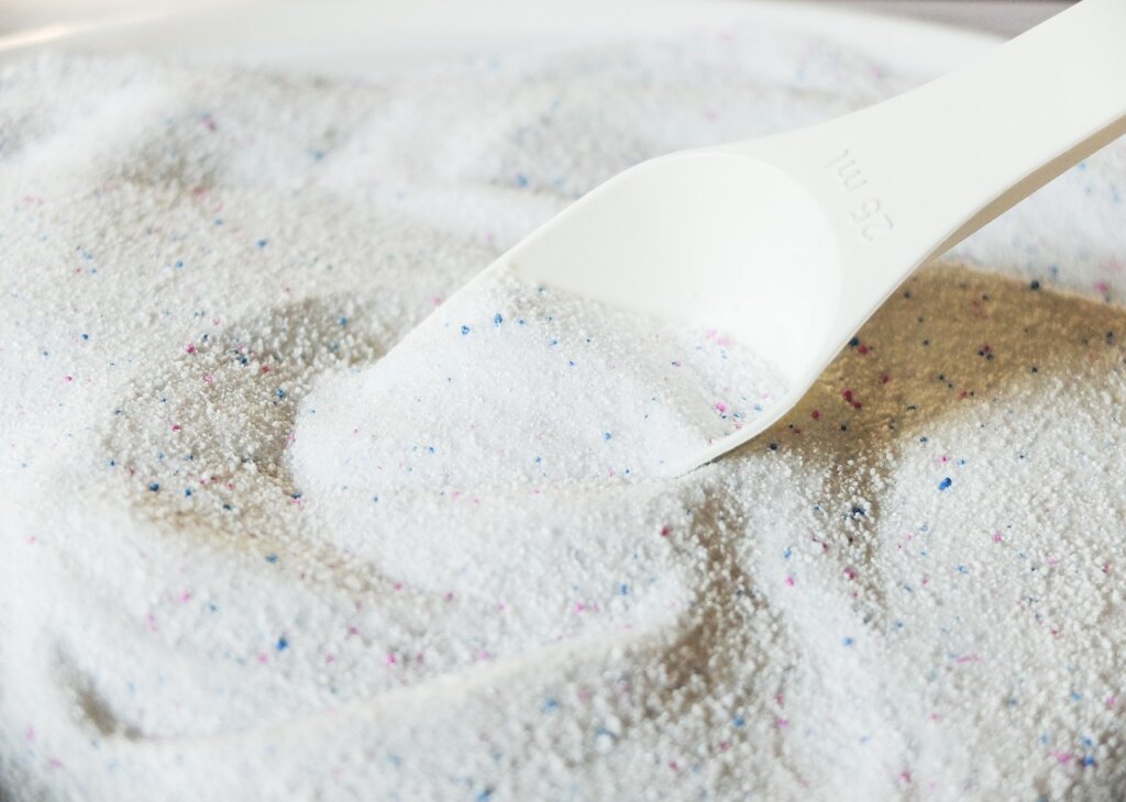 laundry detergent and citric acid powder on washing machine